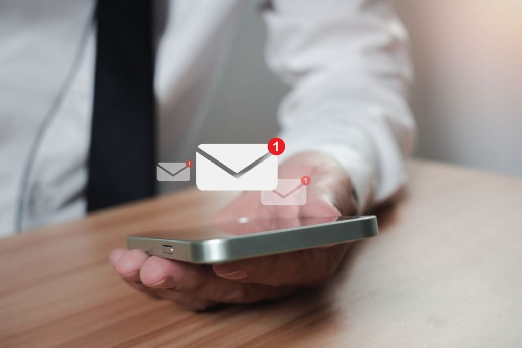 man-holding-phone-with-email-notification-icon